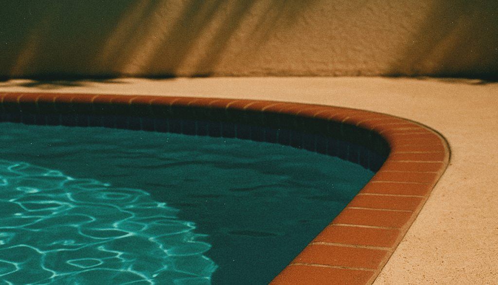 A warm and moody poolside image for a post discussing Forbidden Summer Tropes